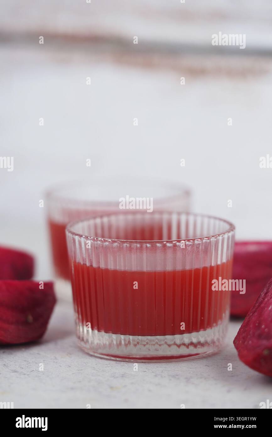 Fresh beetroot juice served in clear glasses on a table Stock Photo
