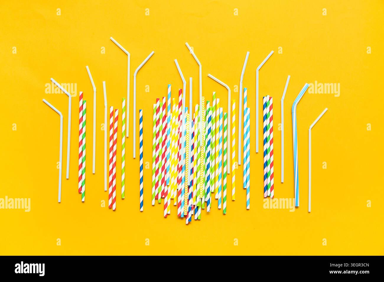 Different drinking straws on orange background Stock Photo
