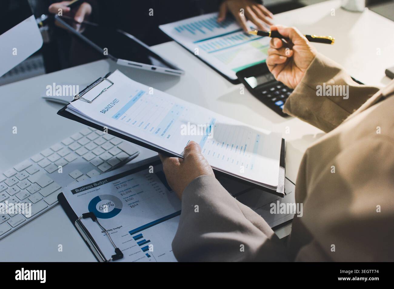 Two young Asian businesswomen discuss investment project working and ...