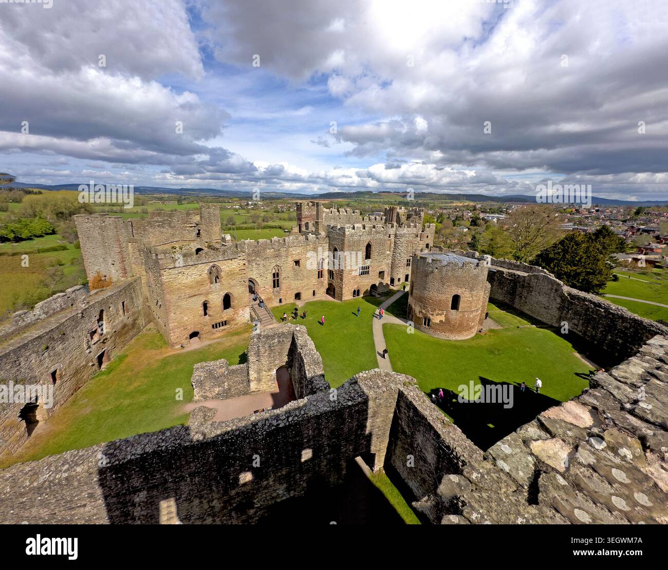 Sunny view over Ludlow Castle ruins, a major Shropshire heritage attraction and historic Welsh Marches fortress.visitors exploring the medieval ruins Stock Photo
