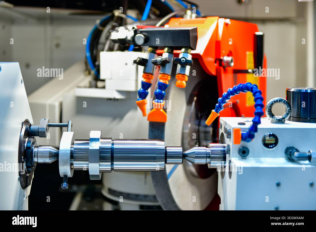Industrial metal working cutting process The raw material bar clamping on the CNC lathe machine Stock Photo