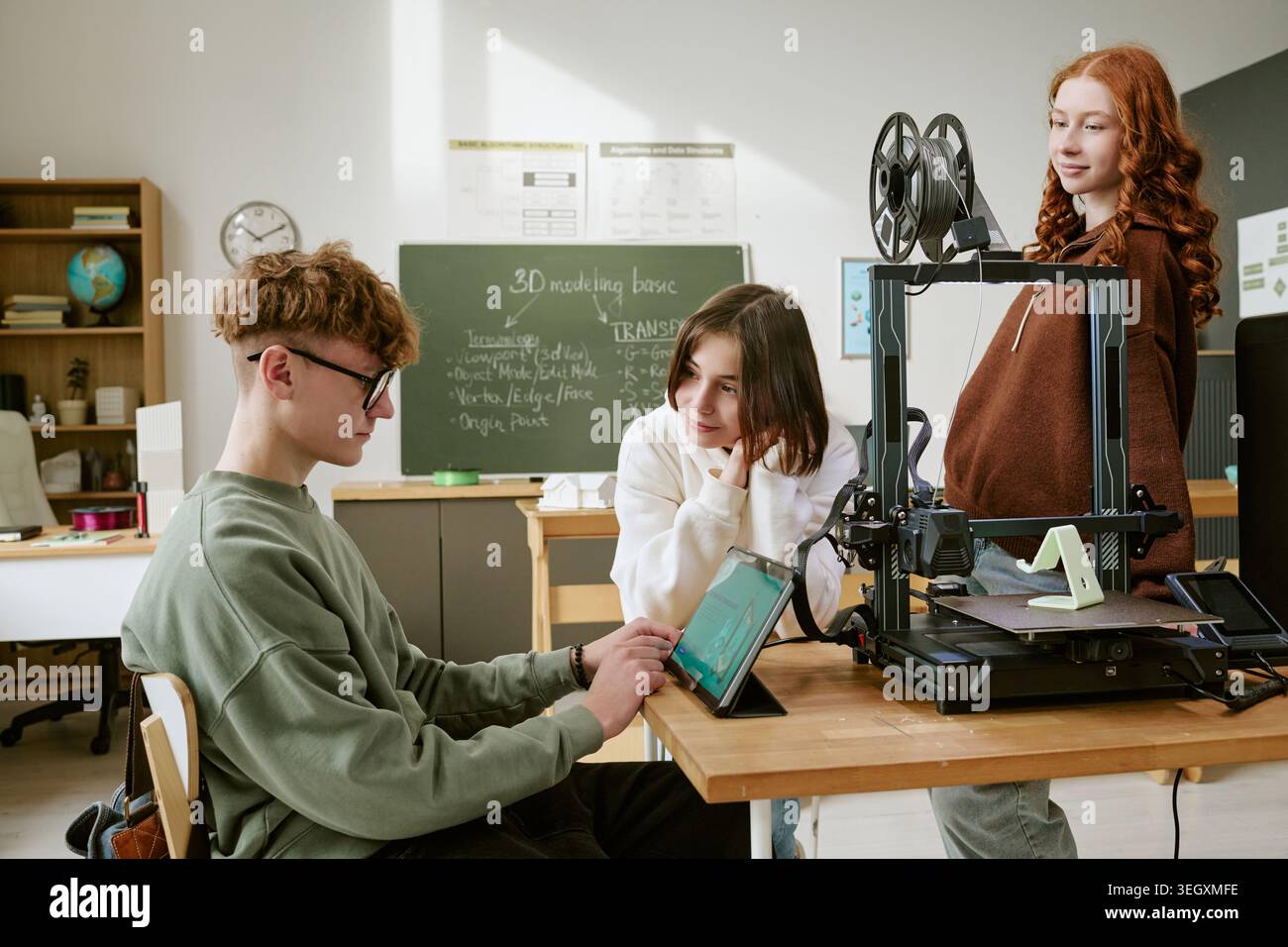 Teenagers Using 3d Printer and Tablet in Classroom Stem Project Stock Photo