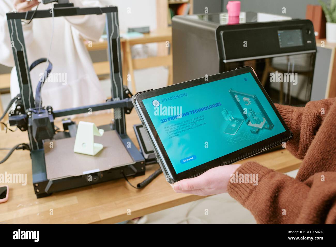 Teenager Using Tablet for 3d Printing Workflow in Classroom Stock Photo