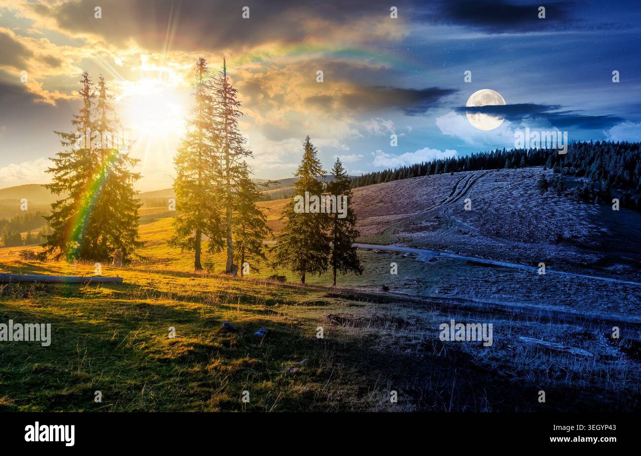day meet night. hillside with coniferous forest on a meadow in mountain landscape on autumn equinox. sun and moon over wonderful view surrounded by sp Stock Photo