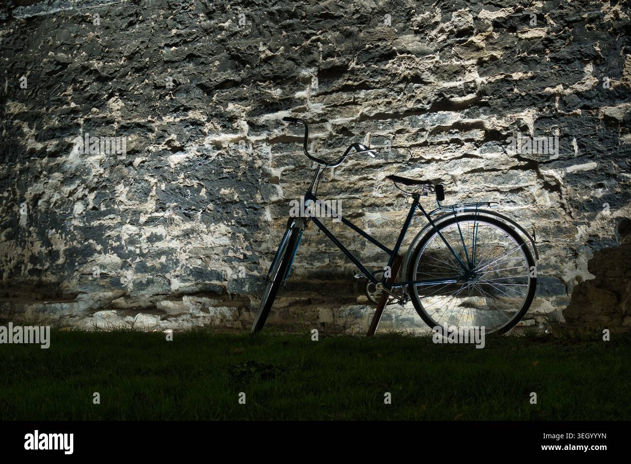 Vintage Bicycle Parked Against a Rustic Stone Wall Stock Photo