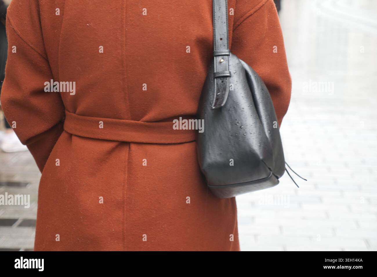 Woman in black coat walks hi-res stock photography and images - Alamy