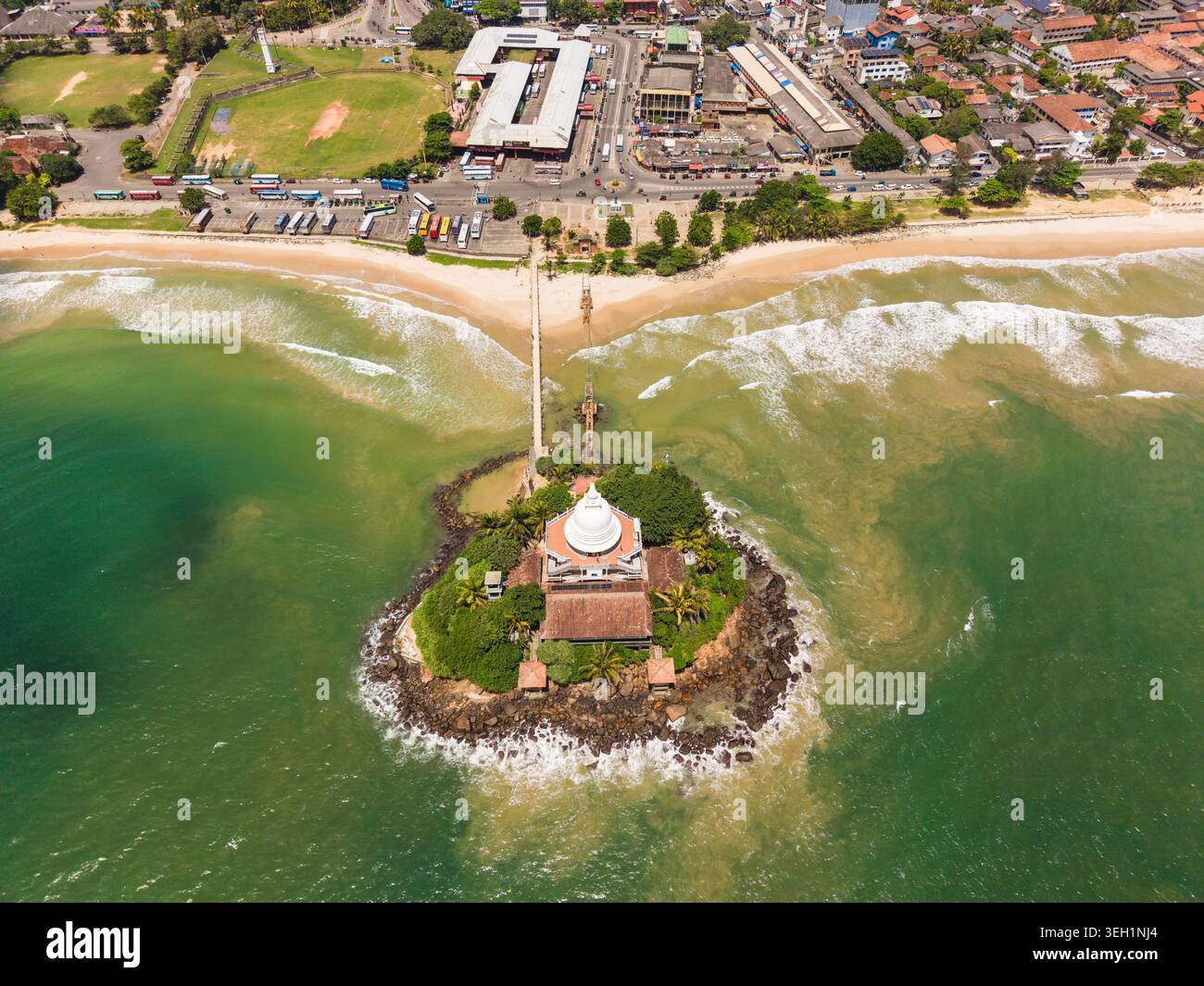 Aerial view of the Paravi Duwa Temple on a small rocky island connected ...