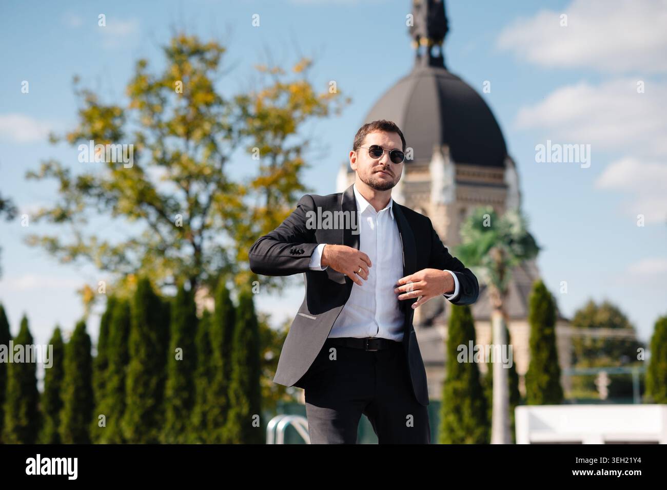 Man in Tuxedo Adjusting Jacket Stock Photo