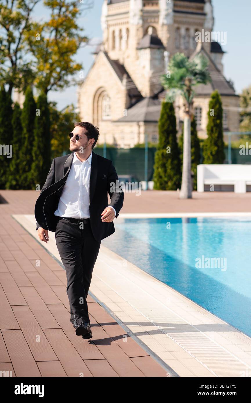 Man in Tuxedo by Pool Stock Photo