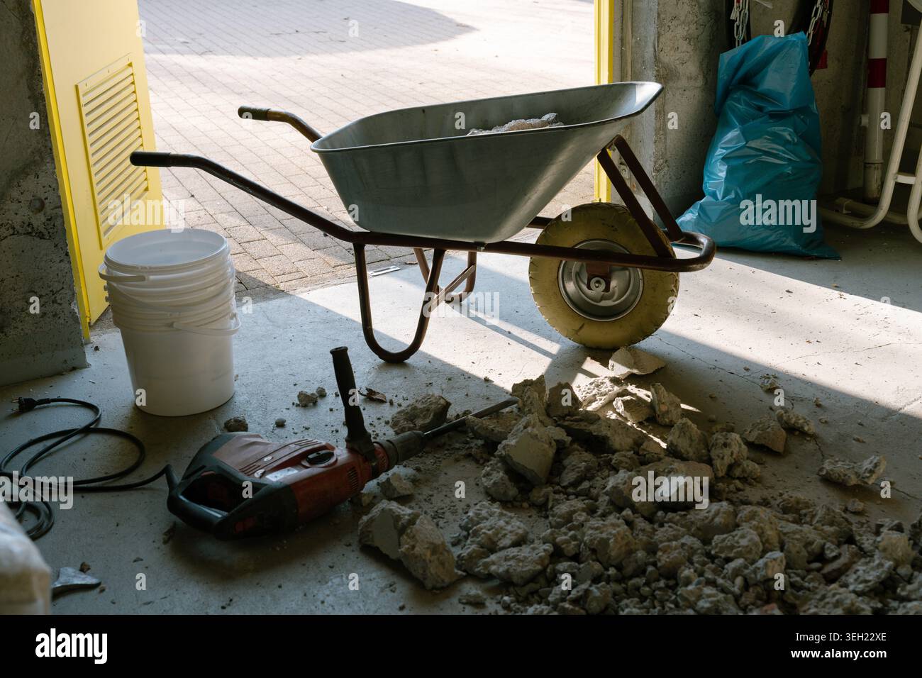 Construction work tools and debris in unfinished interior space Stock Photo