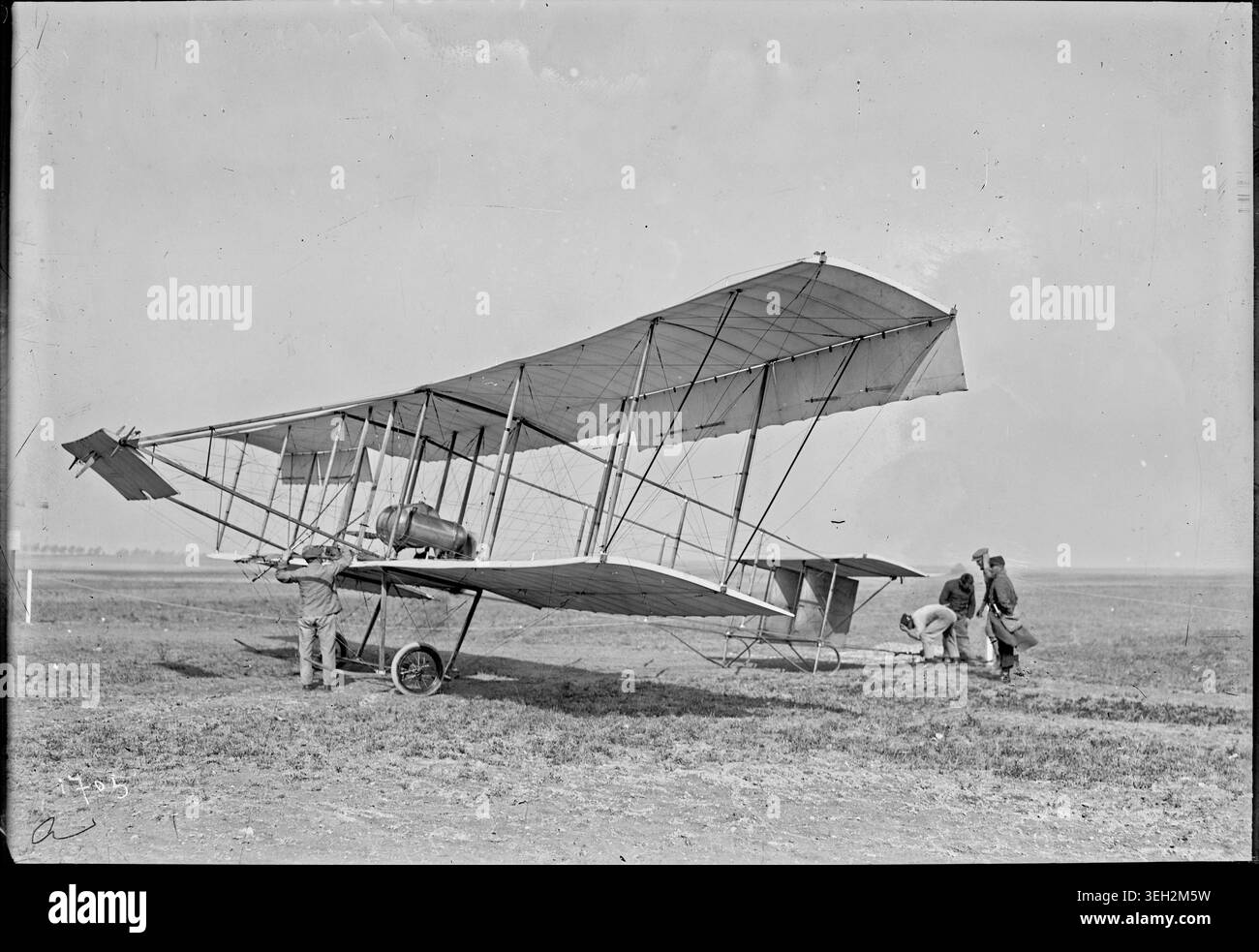 Photographer unknown prepares the Sommer triplace biplane in 1911 at a ...