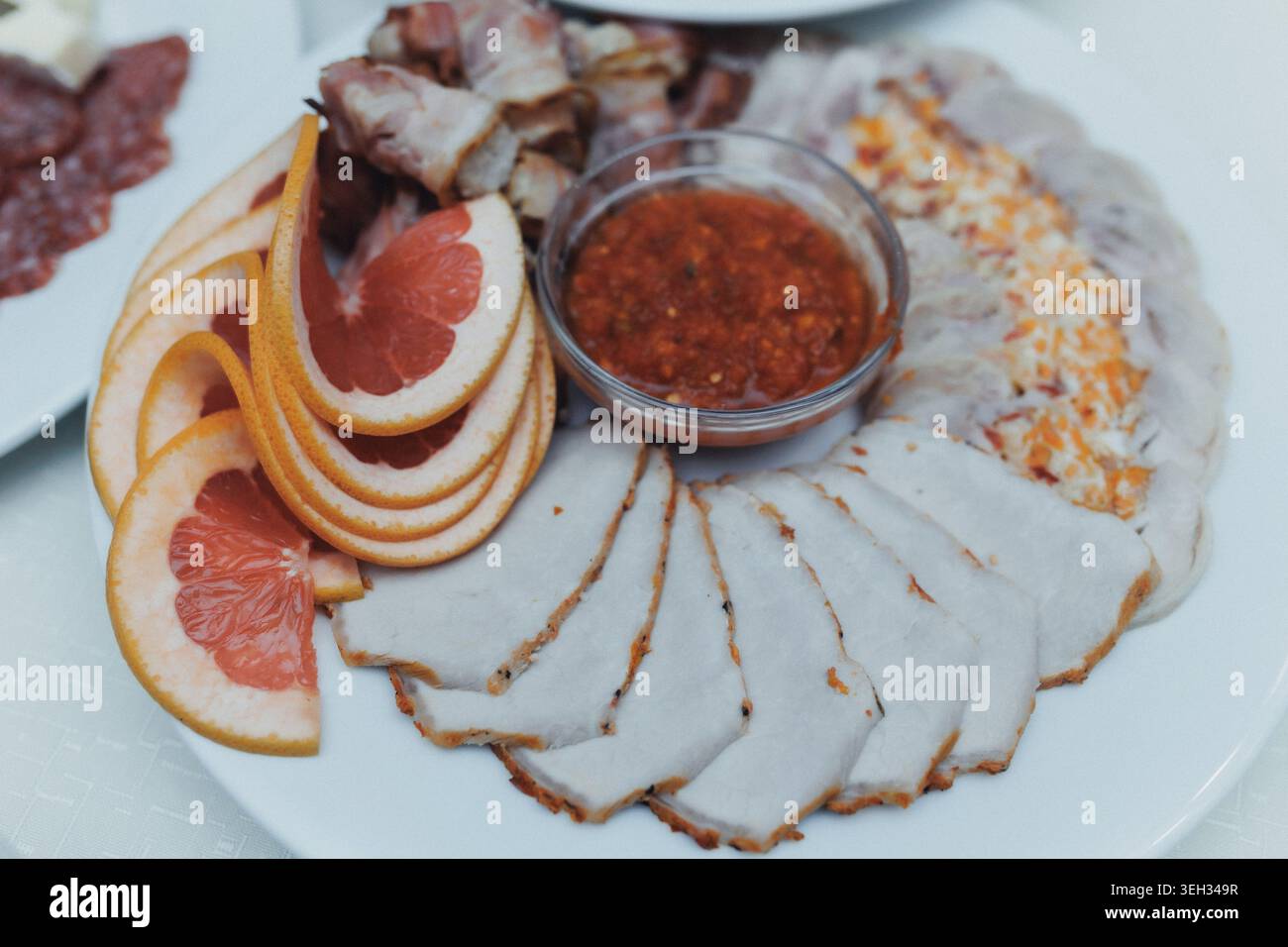 Delicate sliced meat arranged on a white plate Stock Photo