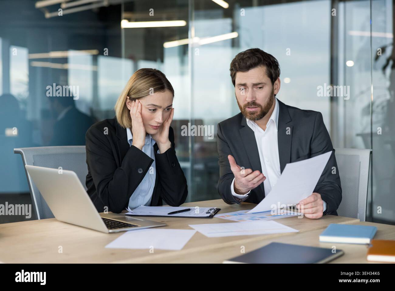Business people working in office, discussing problems and bad news about financial reports, feeling stressed and frustrated with work pressure and failure Stock Photo