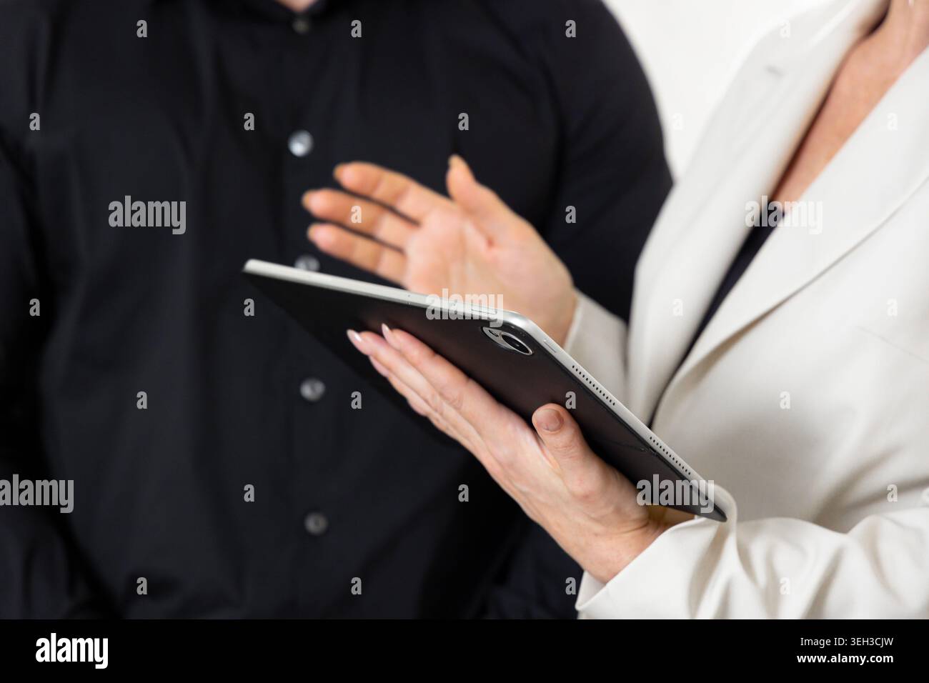 Business Professionals Discussing Project Using Digital Tablet Stock Photo
