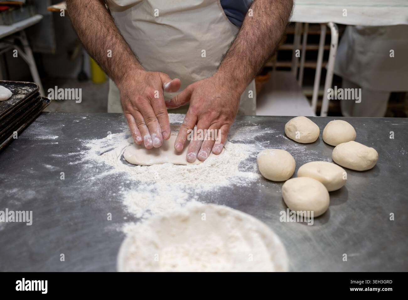 Baker hands kneading dough for artisan bread making Stock Photo