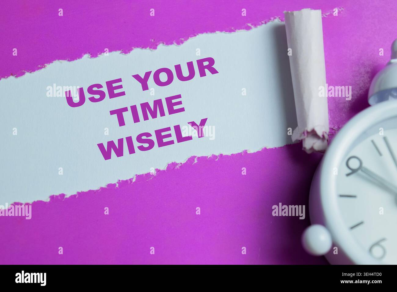 Use your time wisely text written in torn paper. Stock Photo