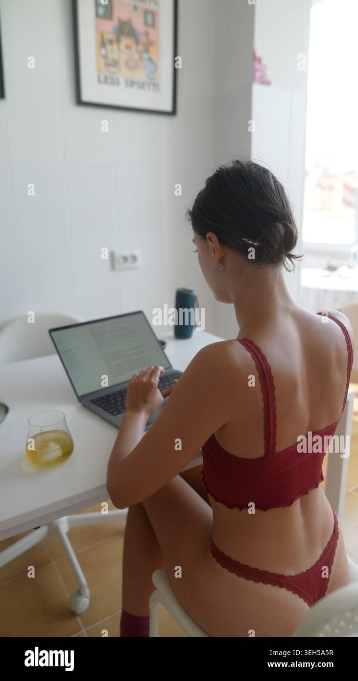 Lady develops visual aids while analyzing graphs on her computer Stock Photo