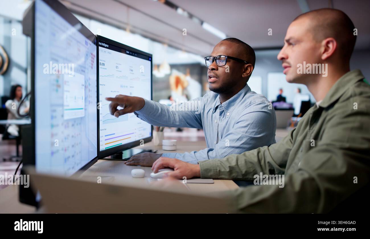 Two Financial Analysts Working Together Using Cloud Software To Process Invoices. Stock Photo