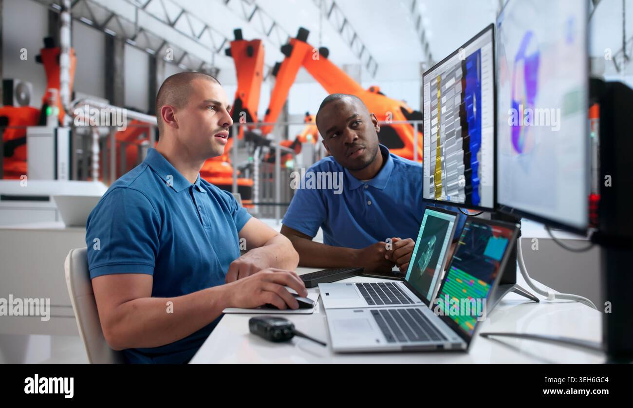 Young Automotive Engineer Uses 3D Simulation Software Analyzing Electric Vehicle Structure. Stock Photo