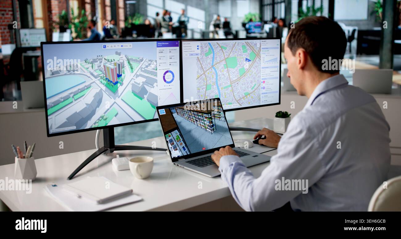 Engineer Studies Urban Property Maps On Laptop Using BIM And GIS Software. Stock Photo