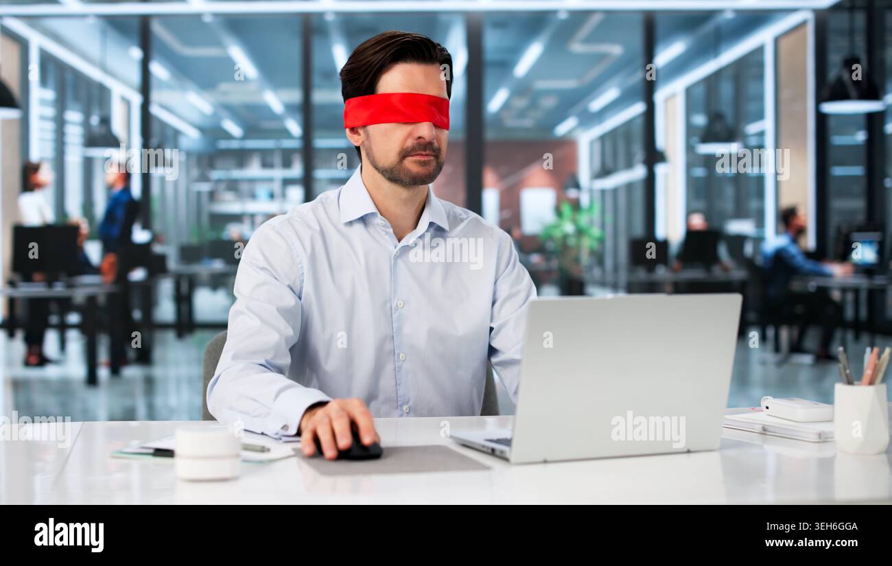 Blindfolded Businessman Typing Focused On Laptop, Solving Problems At Desk. Stock Photo