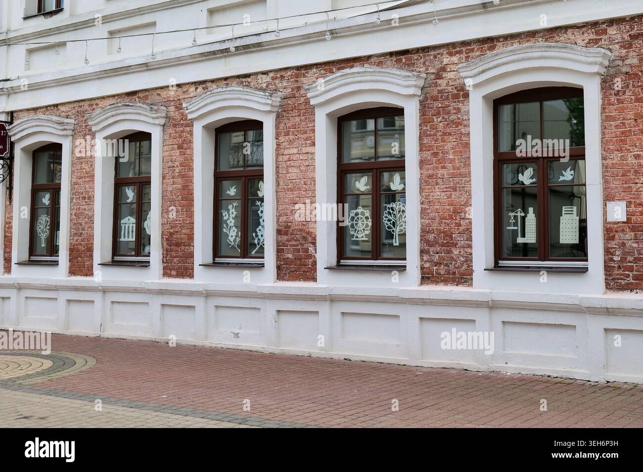 Red Brick Building Facade with Two Windows and White Sills Stock Photo
