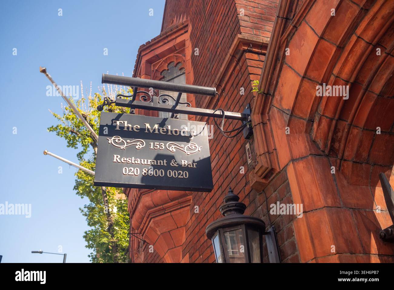 LONDON - APRIL 7, 2026: HAMMERSMITH ROAD – The Melody restaurant and bar sign Stock Photo
