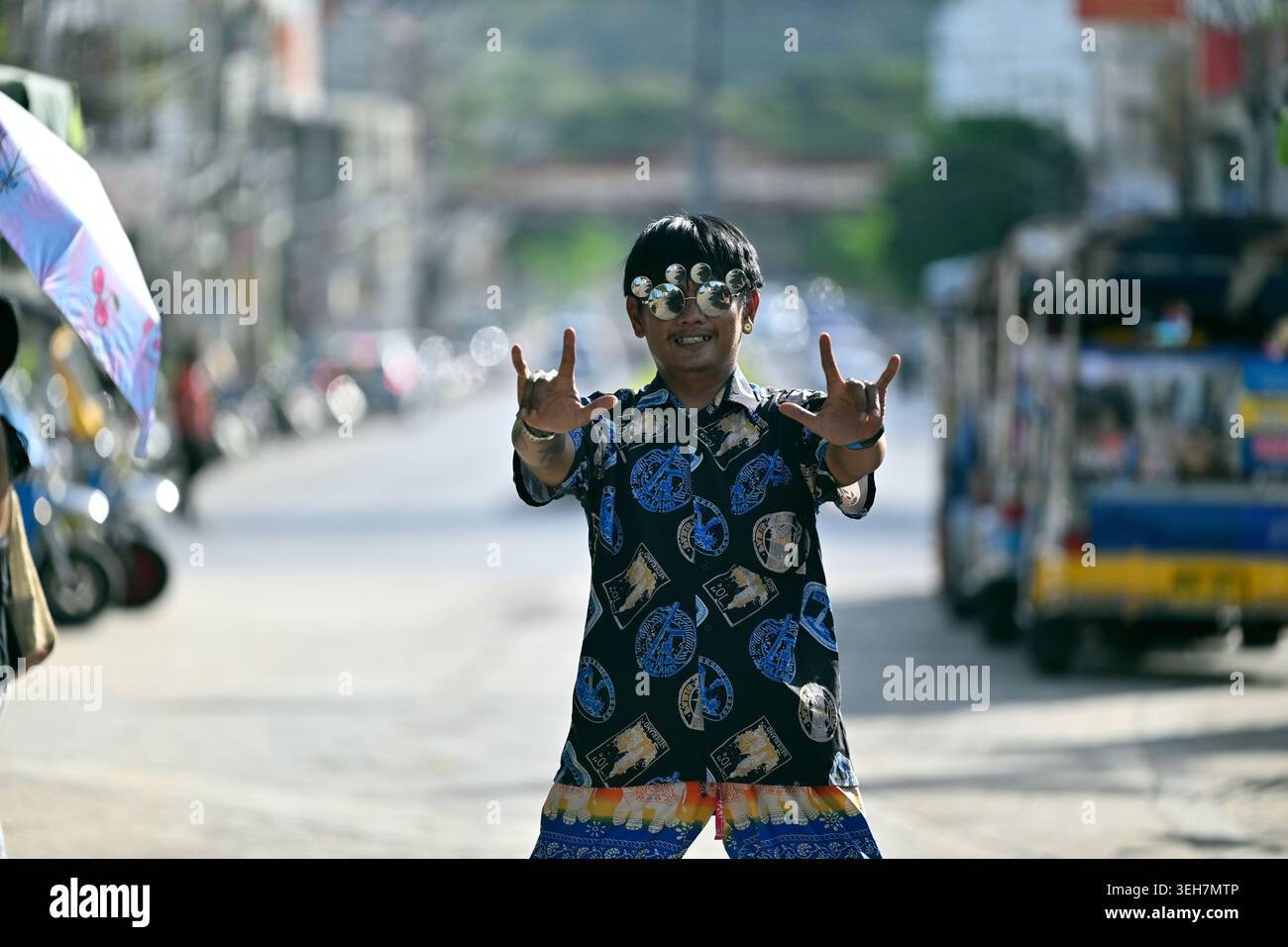 A restaurant owner dresses lavishly and acts flamboyantly to attract customers in Hua Hin, Thailand. Stock Photo