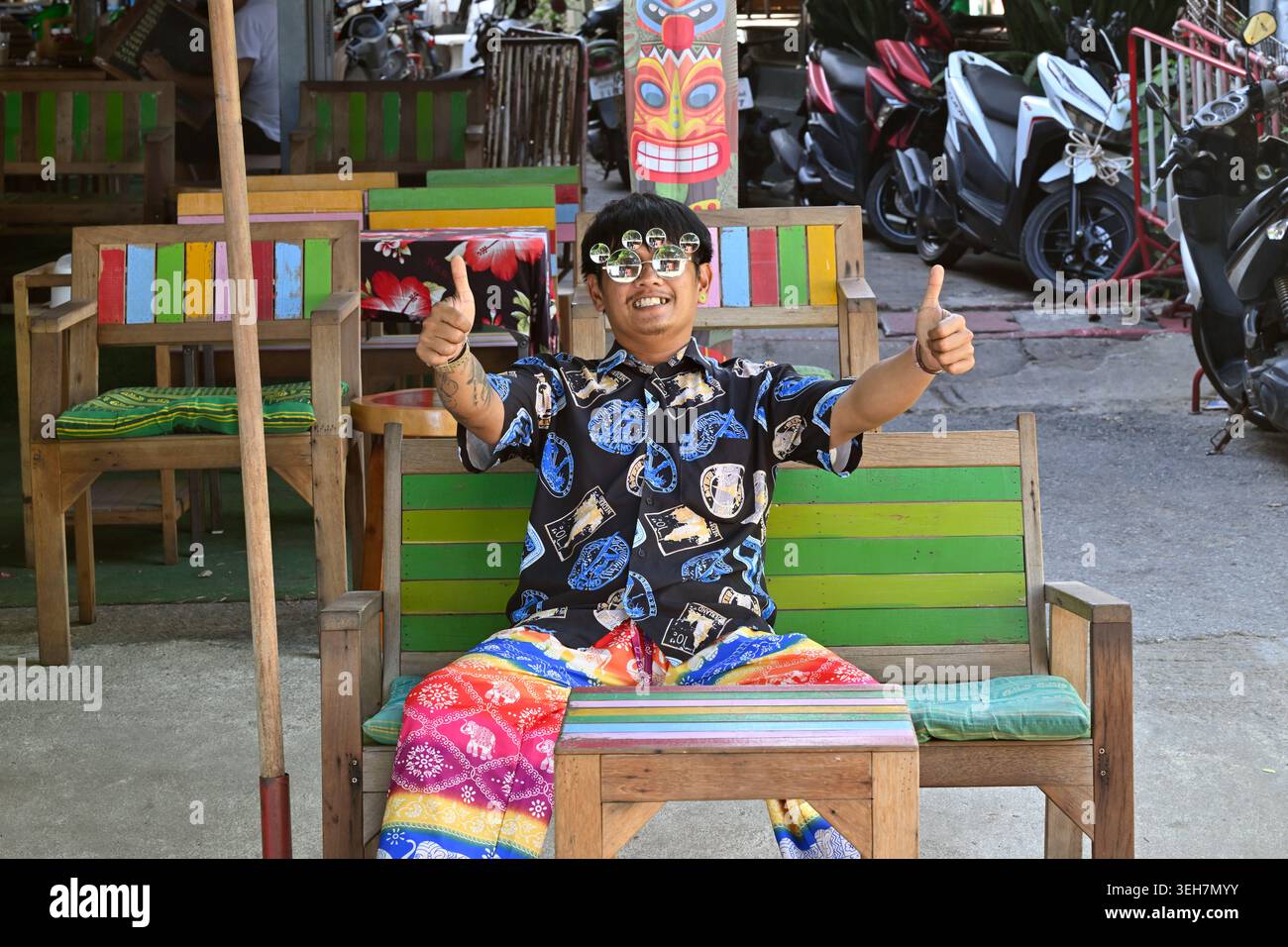 A restaurant owner dresses lavishly and acts flamboyantly to attract customers in Hua Hin, Thailand. Stock Photo