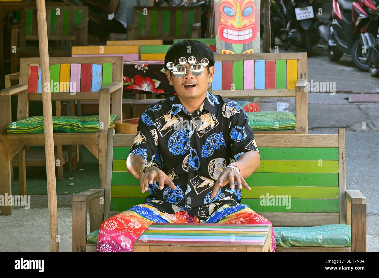 A restaurant owner dresses lavishly and acts flamboyantly to attract customers in Hua Hin, Thailand. Stock Photo