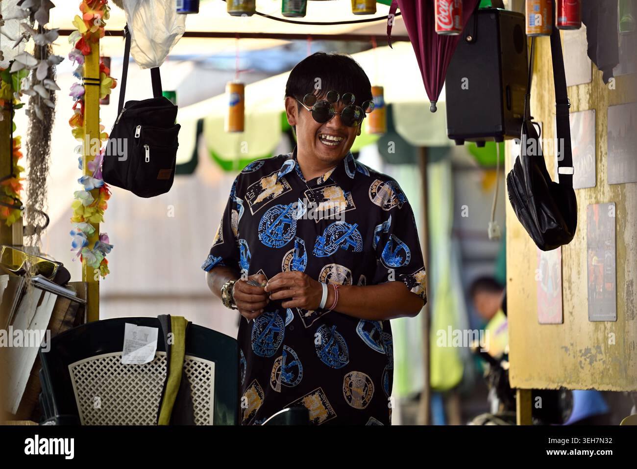 A restaurant owner dresses lavishly and acts flamboyantly to attract customers in Hua Hin, Thailand. Stock Photo