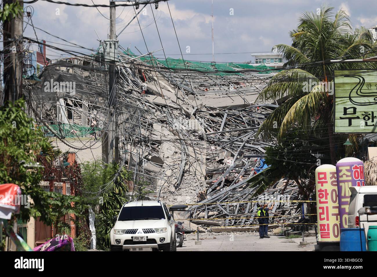 Caution tape marks the area around a collapsed building in Angeles city ...