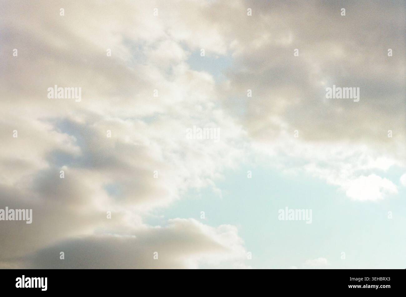 Soft Cloudy Sky Background with Pale Blue Light Stock Photo