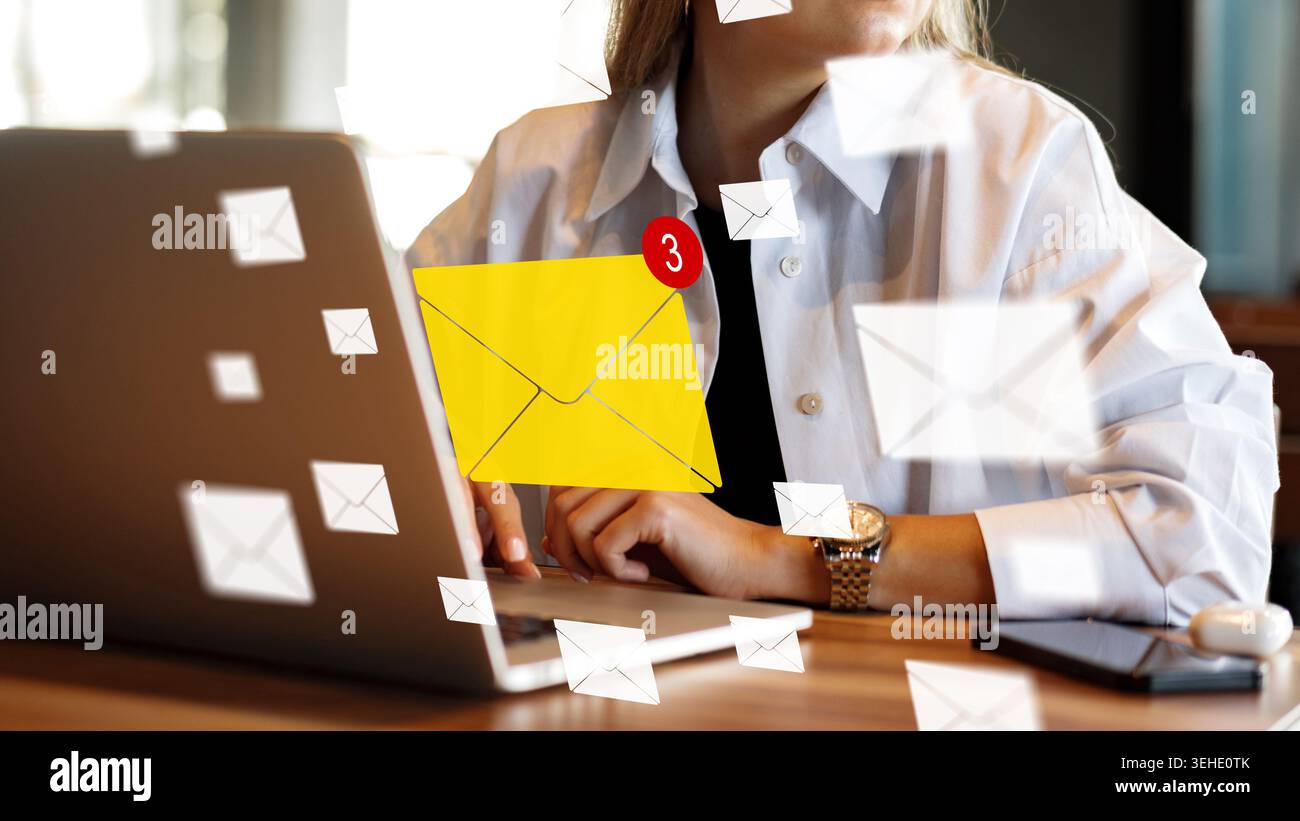 Person checks email on laptop while notifications display on screen Stock Photo