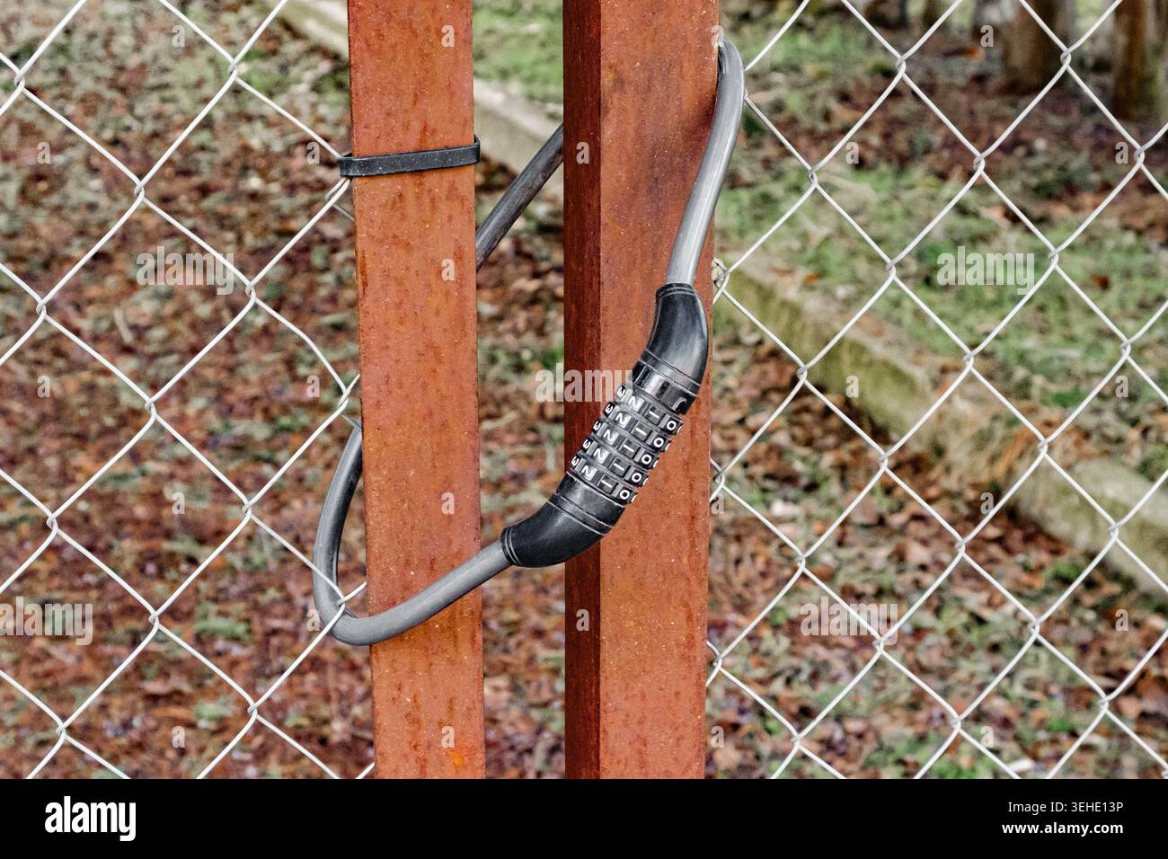 cable combination lock on the hanging gate Stock Photo