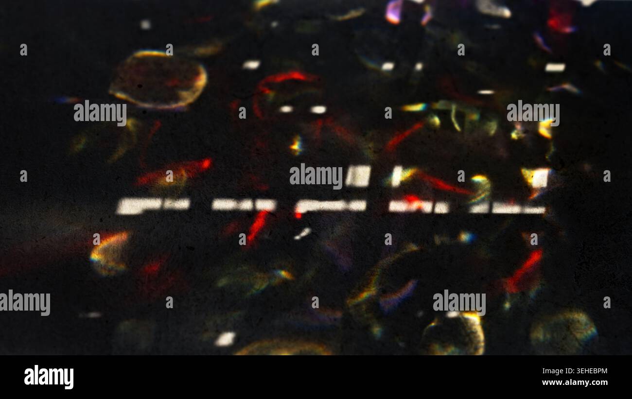 Abstract Light Refractions on Dark Surface Creating Colorful Patterns Stock Photo
