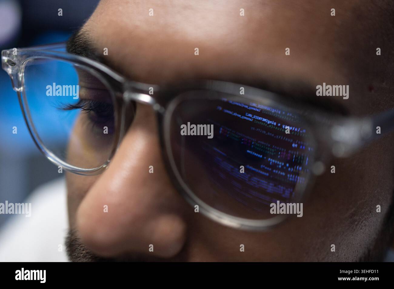 Indian Software Developer Wearing Glasses With Code Reflection On Lens Stock Photo
