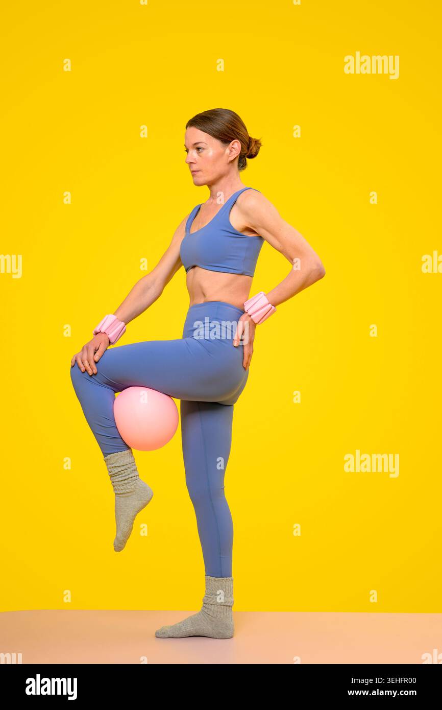 Fit woman doing pilates with a ball Stock Photo