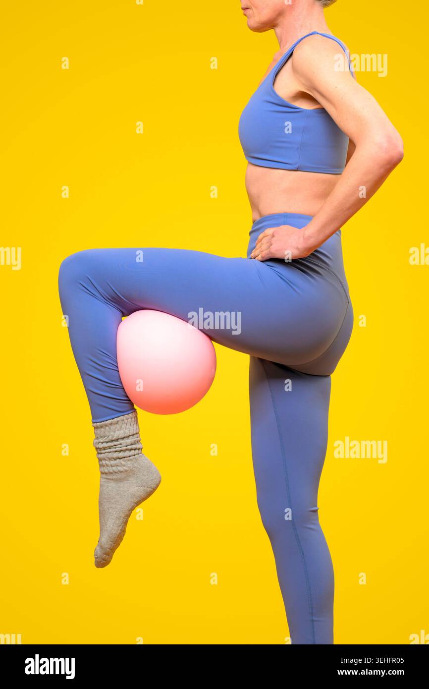 Fit woman doing pilates with a ball Stock Photo