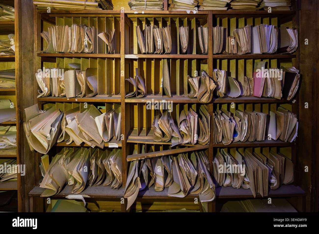 Abandoned archive room. Old documents on shelves. Stock Photo