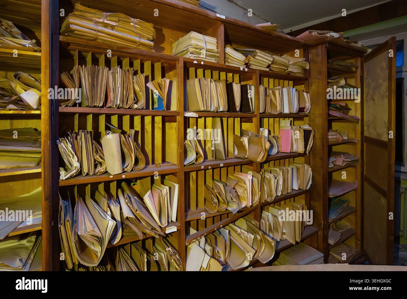 Abandoned archive room. Old documents on shelves. Stock Photo