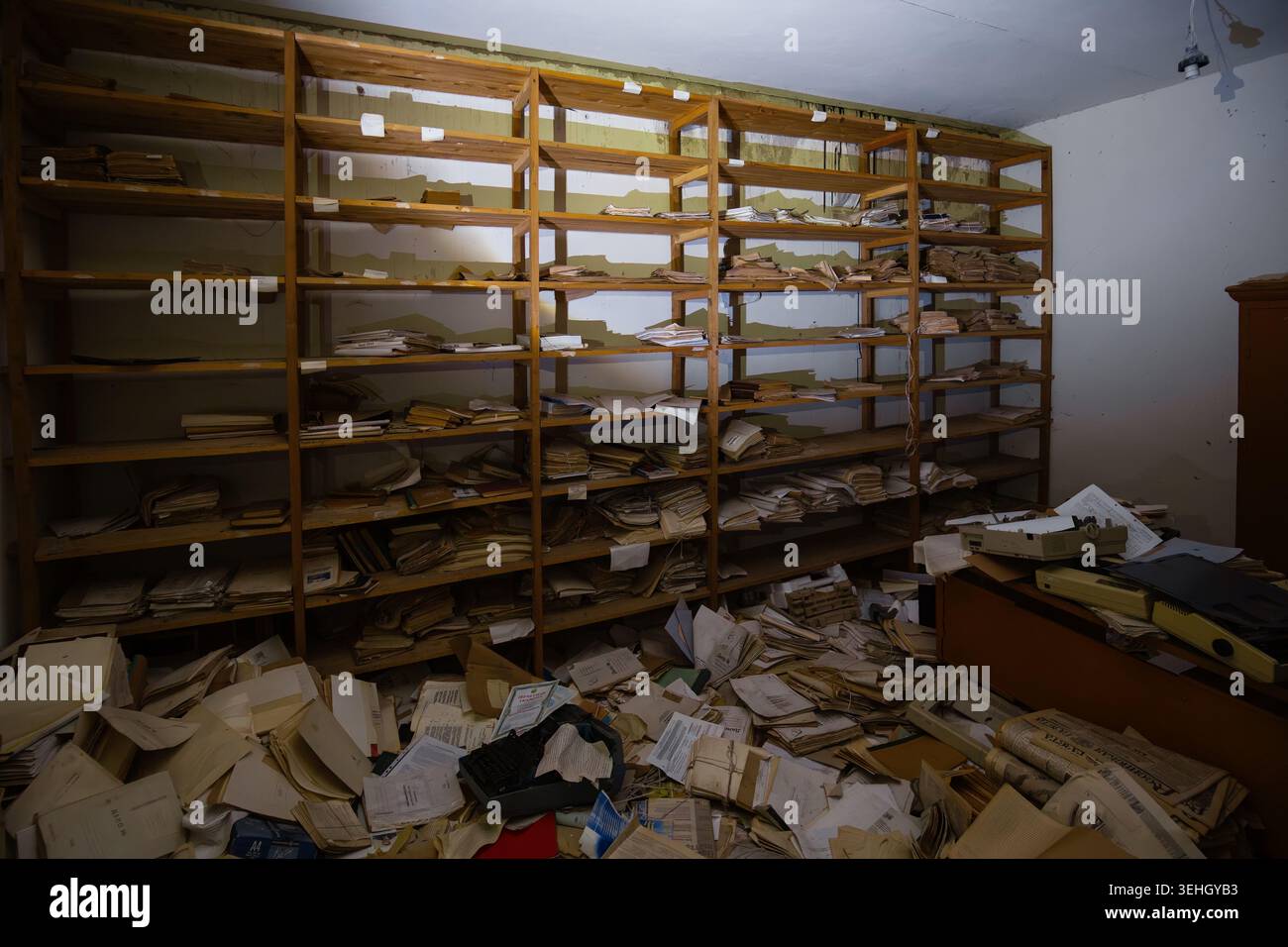 Abandoned archive room. Old documents on shelves. Stock Photo
