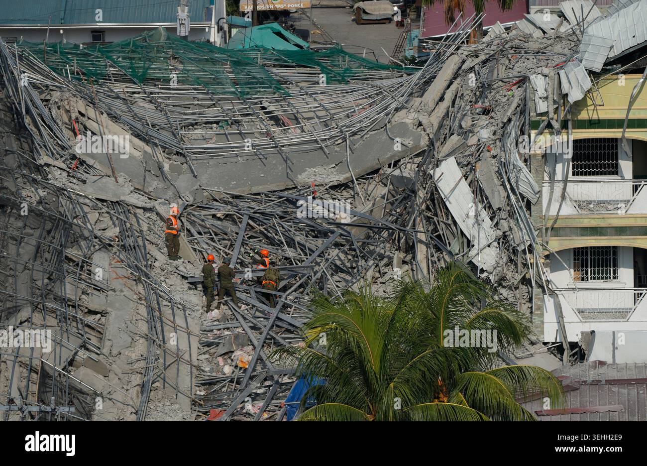 Rescuers continue search operations at a collapsed building where ...