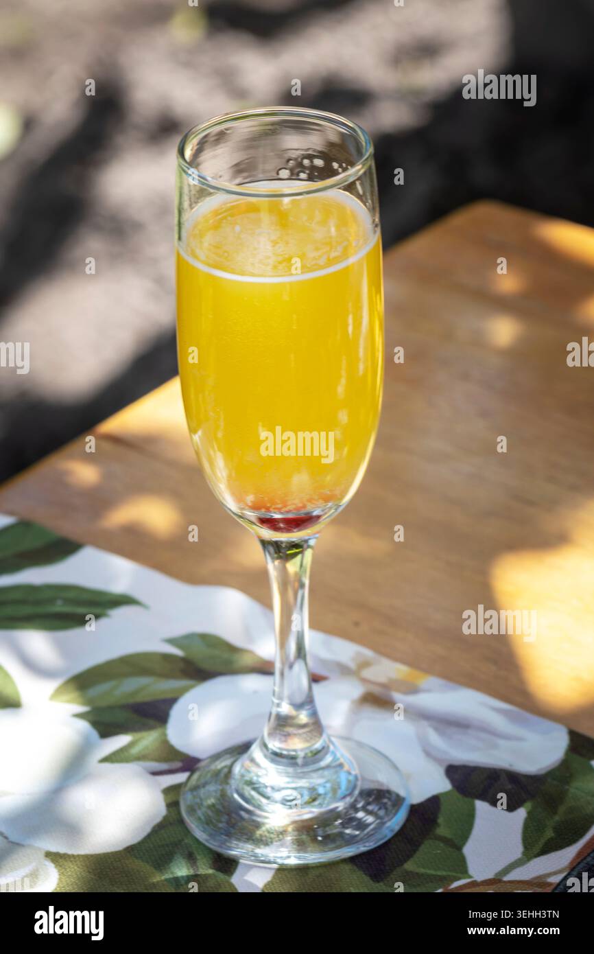 Sparkling tropical mimosa cocktail served outdoors in elegant brunch setting Stock Photo