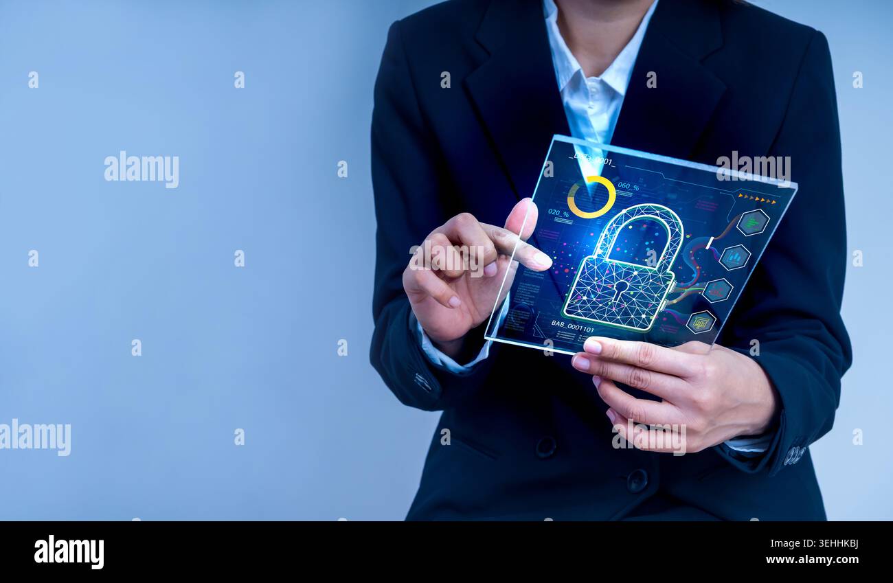 Business professional holding digital tablet with cybersecurity lock icon interface. Data protection, network security, and information security techn Stock Photo