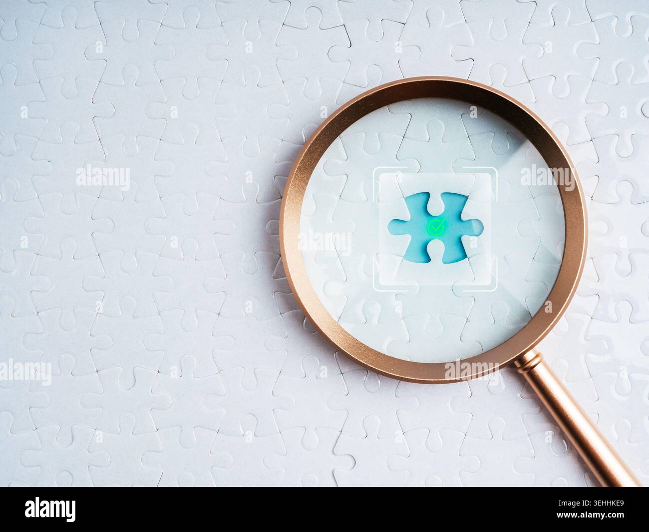 Magnifying glass focusing on missing puzzle piece with checkmark icon. Problem solving, verified solution, data validation, quality control, decision Stock Photo