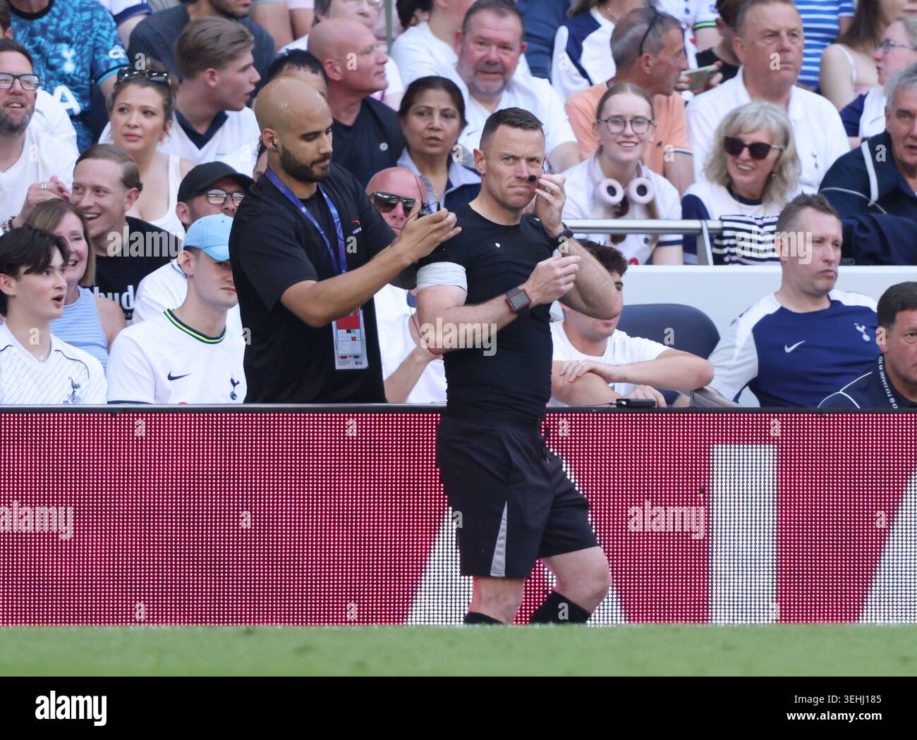The assistant referee has communication problems at the Tottenham ...