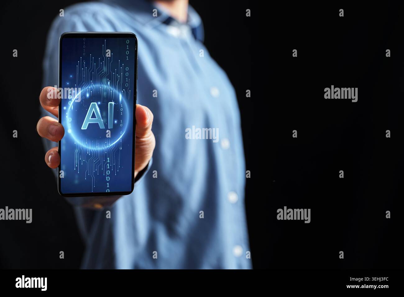Hand holding a modern smartphone screen displaying AI text, representing artificial intelligence technology Stock Photo