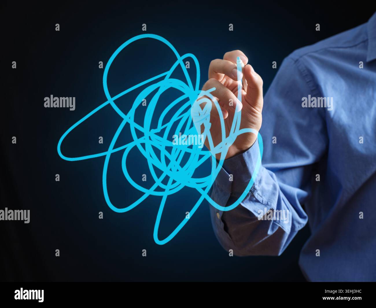 Human hand drawing a glowing blue scribble on a virtual screen, visualizing complexity, chaos, or abstract problem solving Stock Photo