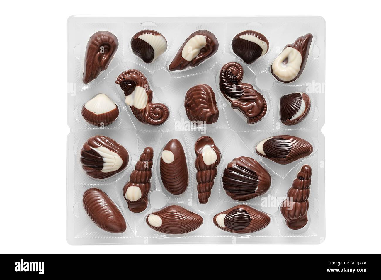 Brown and white chocolates in plastic package isolated on white background Stock Photo